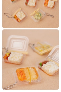 Macro shot of miniature Chinese bento keychain with tiny rice and vegetable details