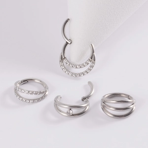 Detailed set of multi-layer G23 titanium nose rings and ear hoops with zircon stones