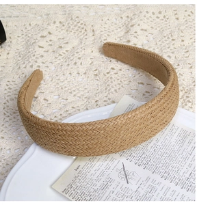 Detail of woven straw texture on beige wide headband with French vintage aesthetic