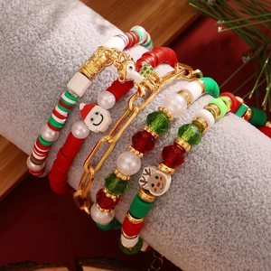 Detailed macro view of 5-piece Christmas beaded bracelet set with Santa and reindeer charms