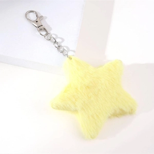 Close-up of a fluffy yellow star-shaped plush keychain with a silver metal lobster clasp