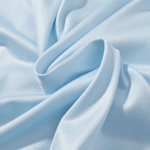Macro detail of the light blue breathable mesh fabric showing textile texture and soft folds