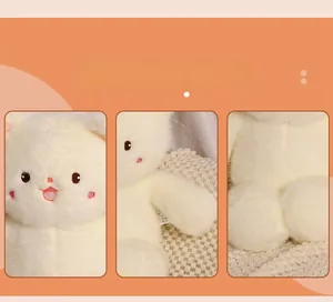 Close-up of white plush cat toy with pink cheeks embroidery and soft long fur texture