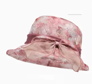 Close-up of pink organza sun hat featuring intricate floral texture and elegant mesh bow
