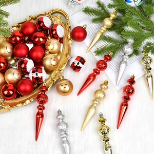 Festive red, gold and silver Christmas ornaments set with finials and baubles on tray