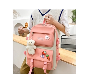 Pink and beige school backpack with plush bear pendant and cute cartoon badges on detail