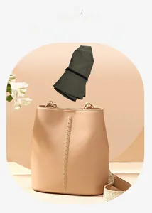 Foldable olive green sun hat shown with a bucket bag to highlight easy storage portability
