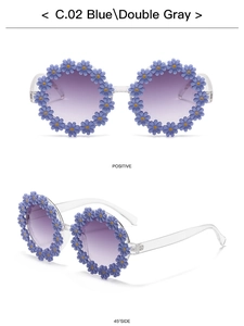 Close-up of kids daisy flower sunglasses with blue frames and purple gradient lenses
