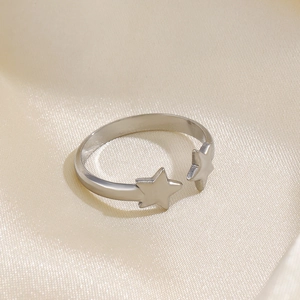 Adjustable silver stainless steel ring with two pentagram stars on silk background