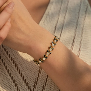 Detail of bohemian gold bracelet with black and clear marquise-cut zircon stones