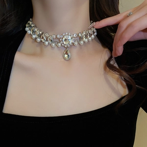 Detailed view of silver choker featuring sparkling flower crystals and drop pearl pendant