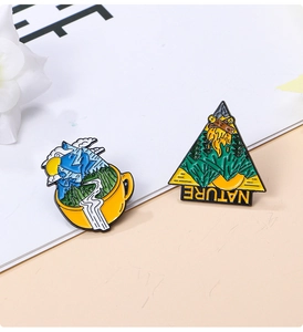 Detail of outdoor camping enamel pins featuring nature landscape and coffee cup designs