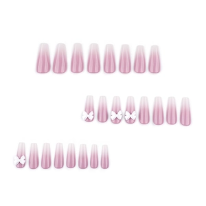 French ombre press-on nails in pink and white gradient with 3D white bow decorations