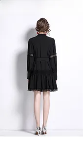 Back view of elegant black long-sleeve dress with detailed lace trim and waist belt