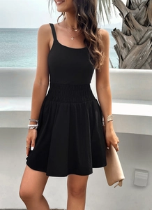 Detail view of the black elegant athletic dress featuring an elastic waist by the beach