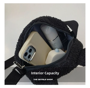 Macro view of the internal capacity of a black plush shoulder bag with zipper closure