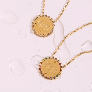Macro view of 18K gold-plated sun pendants with 11:11 engraving and zircon inlays