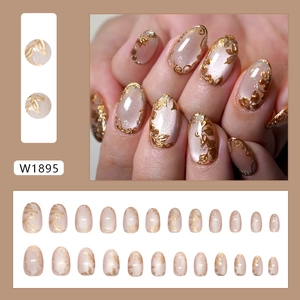 Short oval cat eye press-on nails with 3D gold flower relief and glossy finish