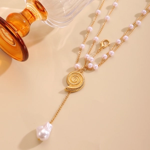 Detail of gold seashell pendant with baroque pearl and pink beads on layered chain