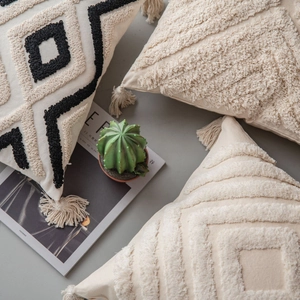 Boho style tufted pillow covers with tassels and geometric patterns in neutral tones