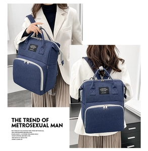 Detail of the navy blue waterproof oxford fabric and wide metal frame opening of the bag