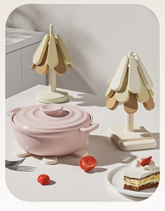 Detail of Christmas tree silicone heat insulation pad with beige kitchen utensil storage