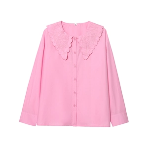 Detailed view of pink cotton shirt featuring intricate floral embroidery on oversized collar