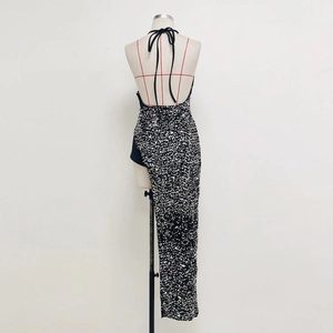 Detailed back view of a sequined backless gown with cross-tie straps on a mannequin
