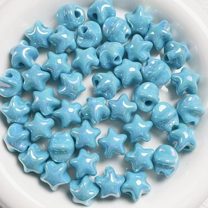 Macro shot of light blue macaron star beads with iridescent coating for DIY jewelry