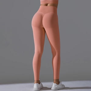 Detail of coral pink seamless high waist yoga pants with scrunch butt lift texture