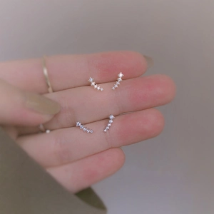 Macro detail of sterling silver wheat ear ear studs with sparkling white cubic zirconia