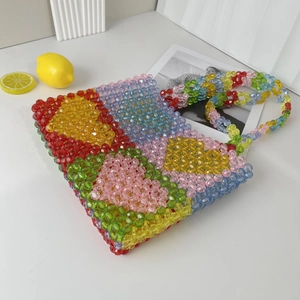 Macro detail of colorful acrylic beaded tote bag with vibrant geometric color block patterns