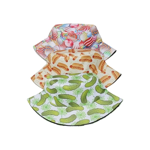 Detailed stack of three bucket hats with lollipop, hot dog, and cucumber prints