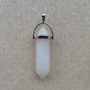 Macro shot of white hexagonal crystal pendant with a polished silver metallic bail