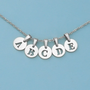 Close-up of stainless steel necklace with A to E hollow alphabet letter pendants