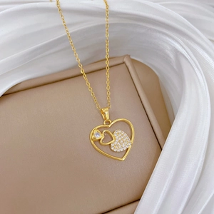 Detailed view of a gold hollow heart pendant necklace with shimmering zircon inlay