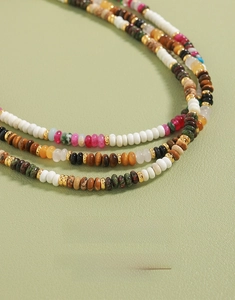 Detail of bohemian tiger eye necklace with colorful beads and gold metal spacers