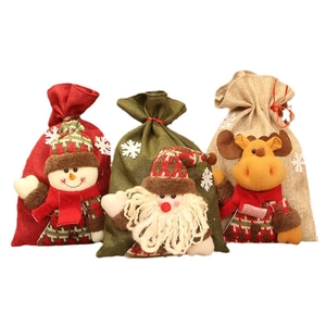 Three-piece Christmas drawstring burlap gift bags with 3D Santa, Snowman, and Reindeer dolls