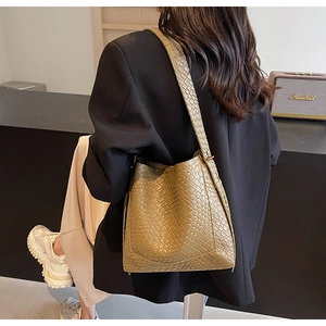 Detail of khaki woven texture shoulder bag with stylish bucket silhouette for women