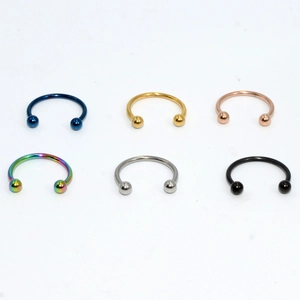 Detailed set of horseshoe circular barbells in silver, gold, black, and multi-color finishes
