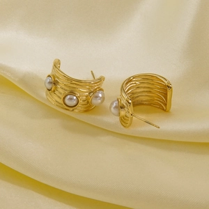 Elegant 14K gold C-shaped earrings with textured wave metal and white pearls on satin
