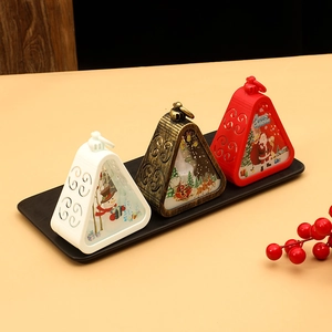 Close-up of Christmas lanterns with snowman and Santa patterns in white, bronze and red