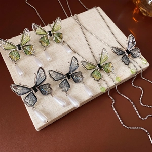 Diamond butterfly tassel necklace with translucent wings and pearl pendant accents