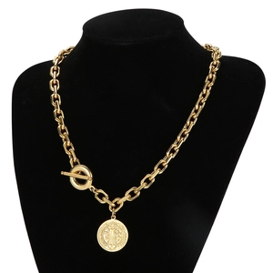 Vintage gold coin pendant necklace with chunky chain on a black mannequin display