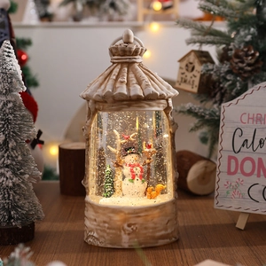 Macro view of a retro Christmas lantern with a snowman and a liquid snow effect