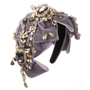 Detailed view of luxury velvet headband with sparkling crystals and bow embellishments