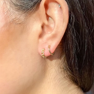 Elegant gold chain link earrings and smooth hoop earring set on earlobe model