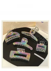 Detailed view of five large holographic shark clips in various elegant geometric shapes