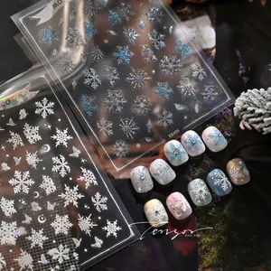 Detail of KX495 winter snowflake nail stickers with 3D white and holographic blue patterns
