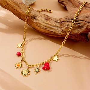 Vintage gold layered chain necklace with sun, star, and red cherry fruit pendants
